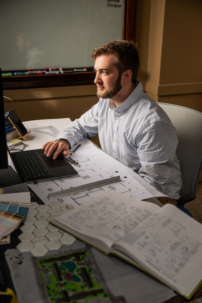 A student at a desk doing design studies work.