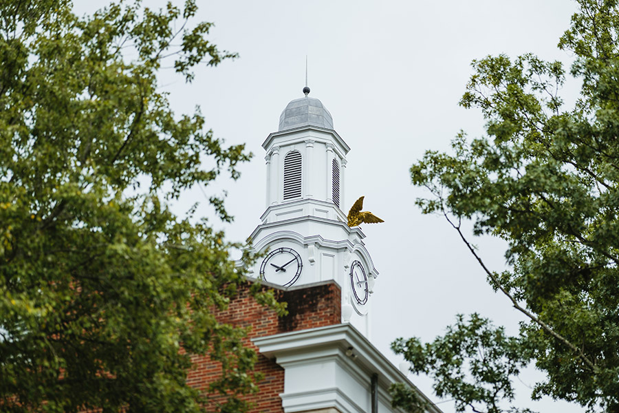 A zoomed in view of the top of Derryberry Hall with the Golden Eagle statue.