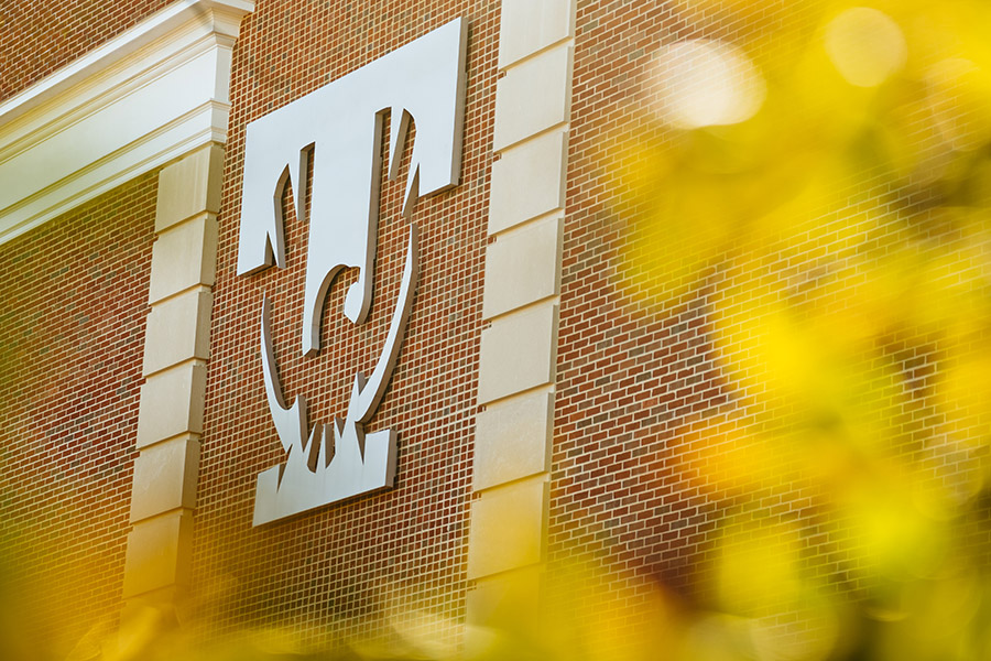 The university logo on the back wall of Derryberry Hall.
