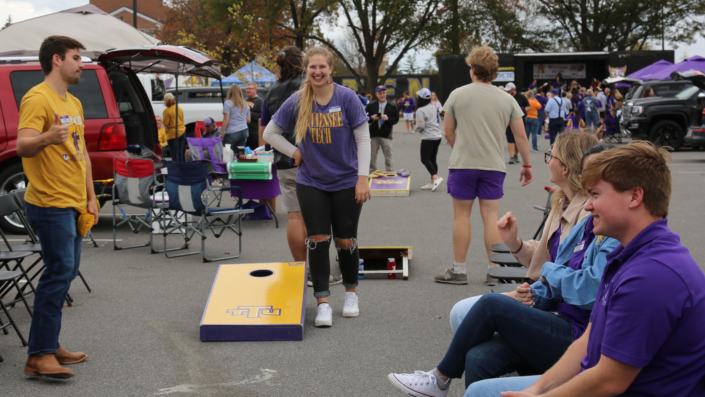 students playing cornhole at homecoming