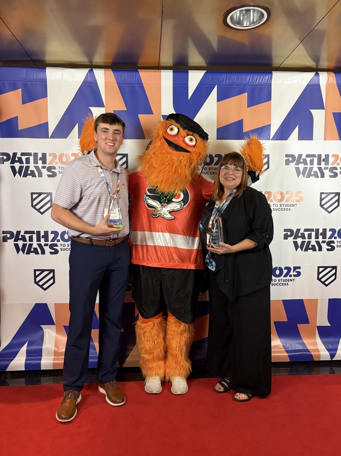 Carter Lay and Sherry Cannon with the Philedelphia mascot holding their awards at the Pathways 2025 conference