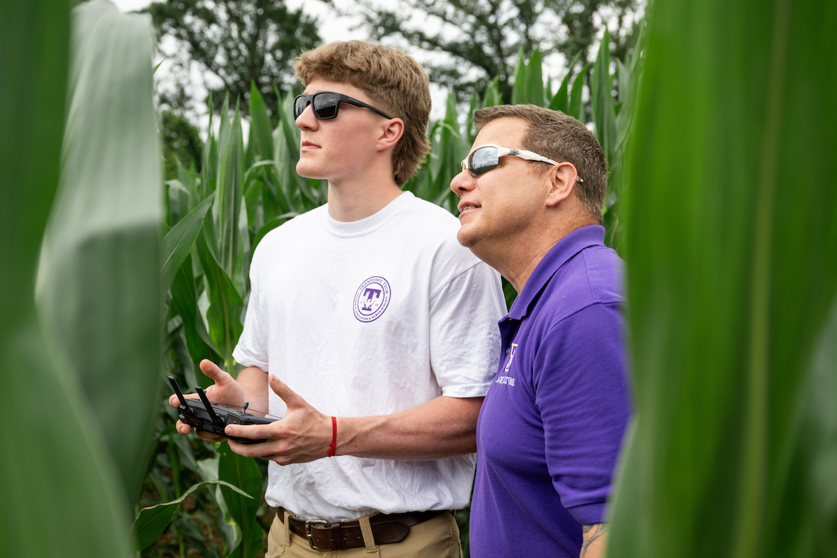 Student is getting a lesson on how to fly a drone.