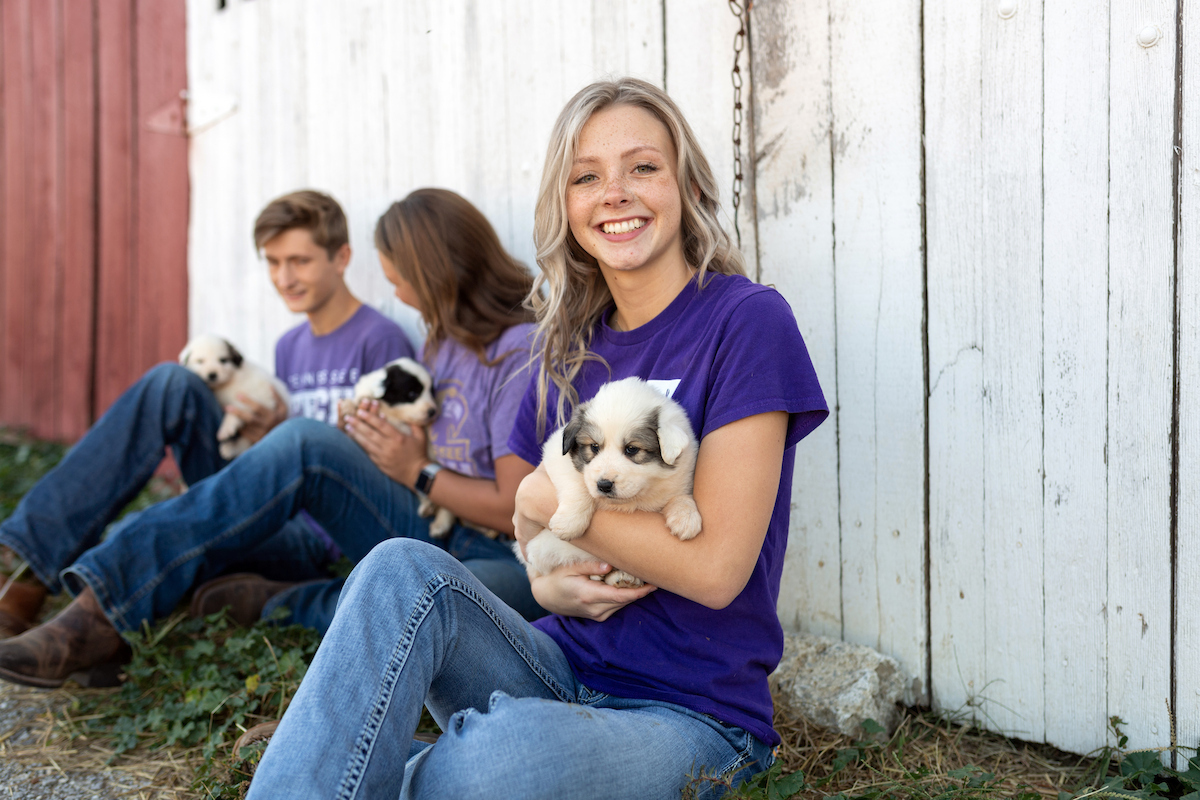 Student holds a puppy