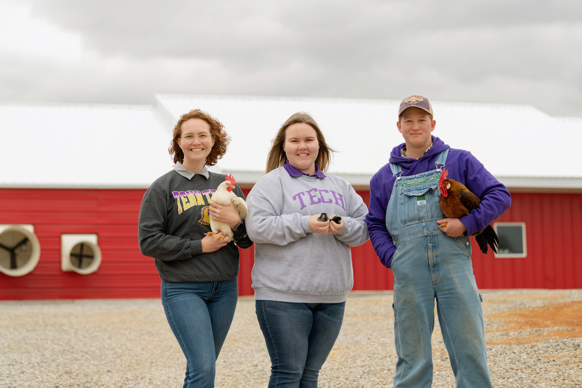 Tennessee Tech poultry science students pose with chickens outside the Poultry Science Research Center.