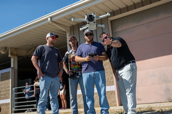 Students learn drone operation during a hands-on agricultural engineering technology field exercise.