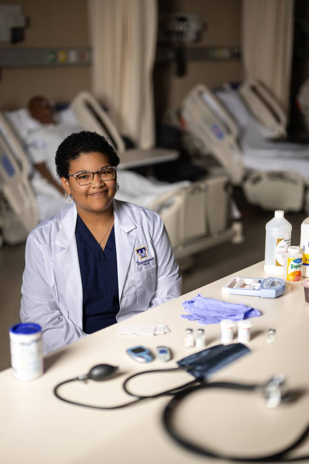 Nutrition student sitting in hospital room working