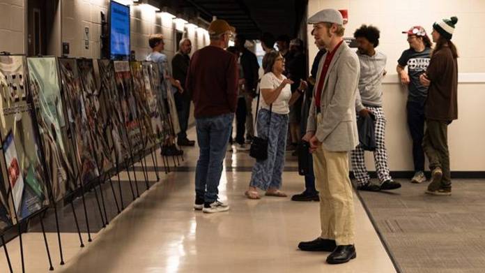 Festival attendees view film posters and gather between screenings at the Reel Tech Film Festival.