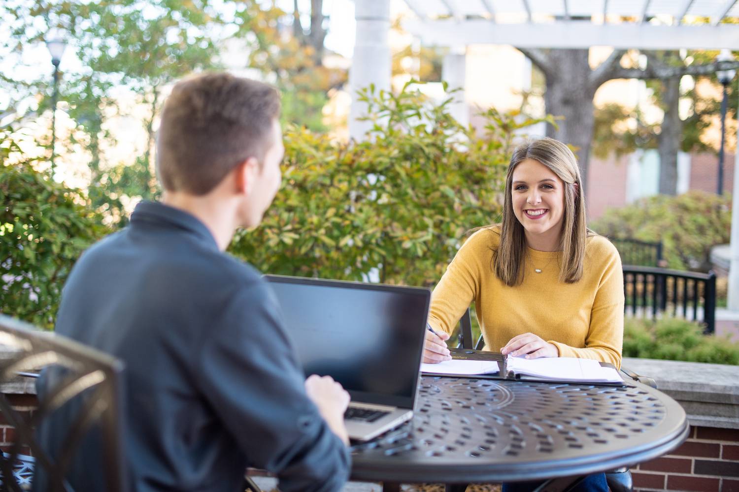 students sitting in Centennial plaza