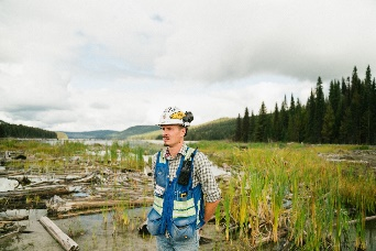 Waste Management Photo showing a worker standing in a marsh