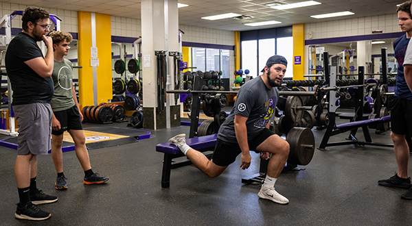 Majors working on stretching techniques in the training room.