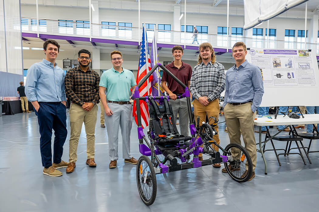 A photo of team of 6 students presenting their capstone project
