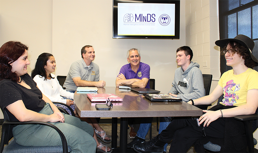 MInDS center advancing AI at Tennessee Tech Two professors and four students sit around a table together