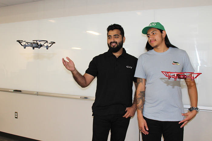 Ask AI: A look at artificial intelligence and its impact at Tech Two students stand next to drones hovering in classroom