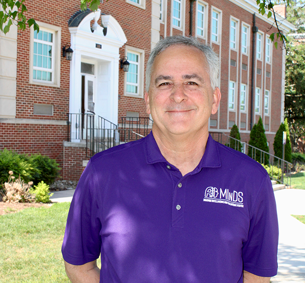 MInDS Co-Director and Professor of Computer Science, Dr. Bill Eberle, stands in front of Bruner Hall