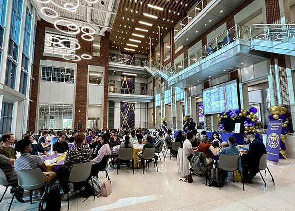 a group of people at an event in the Ashraf Islam atrium