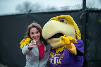 student and Awesome Eagle giving wings up sign