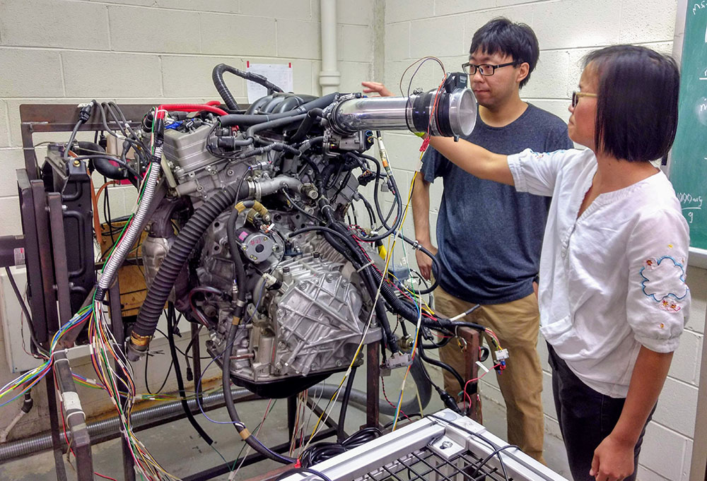 Two students working in the Automotive Powertrain and Emissions Control Lab