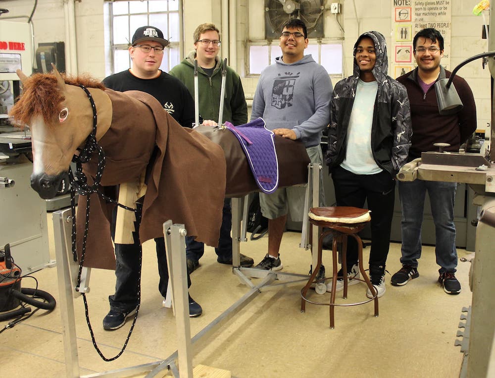 Students standing next to their project