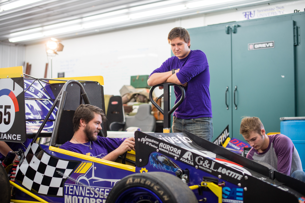 Students working on car