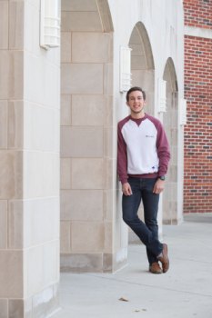 Student leaning against a pillar