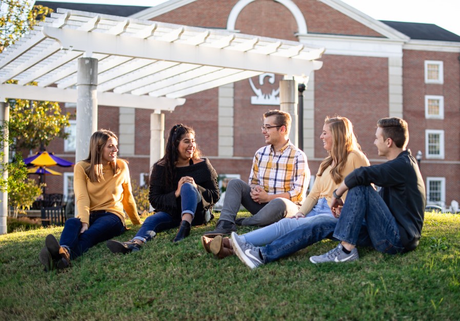 Five students sitting outside Centennial Plaza at Tennessee Tech