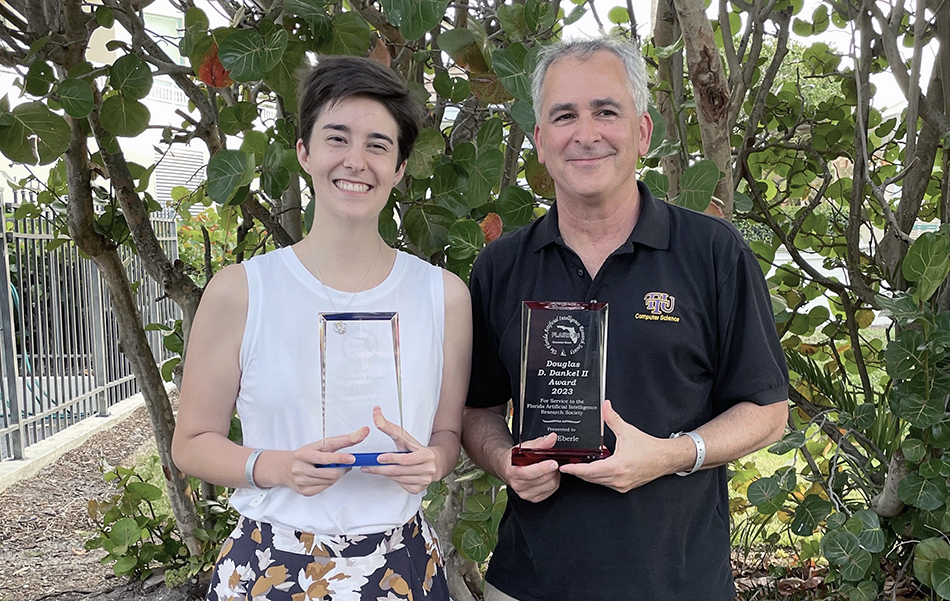 Tennessee Tech wins awards, presents research at Florida artificial intelligence conference Bill Eberle and a student stand together outside while smiling and holding awards