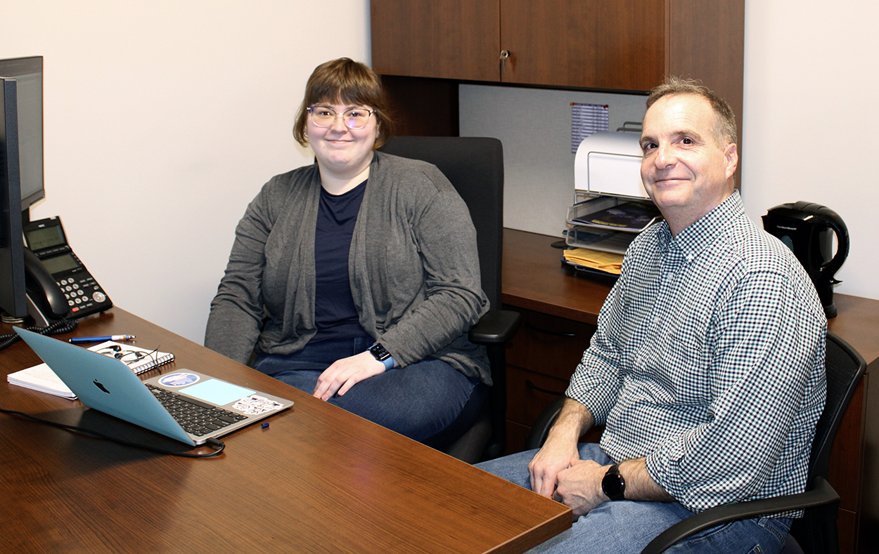 Katie Brown and Doug Talbert sitting at a desk