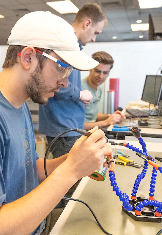 Students work on an electronics project in an engineering laboratory.