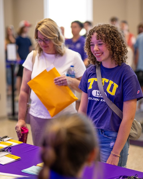 Picture of student talking to office member