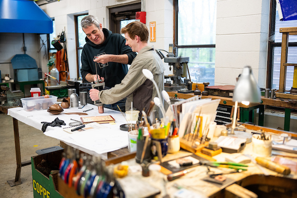 A professor and student working together in a Wood Shop class.