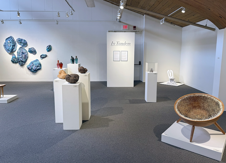 exhibition title on wall with works surrounding