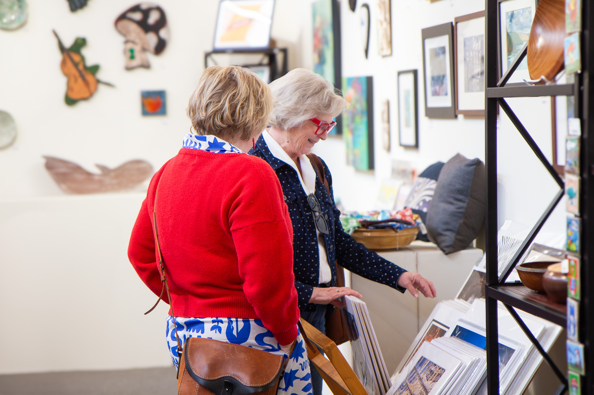Two people browsing goods in the gallery
