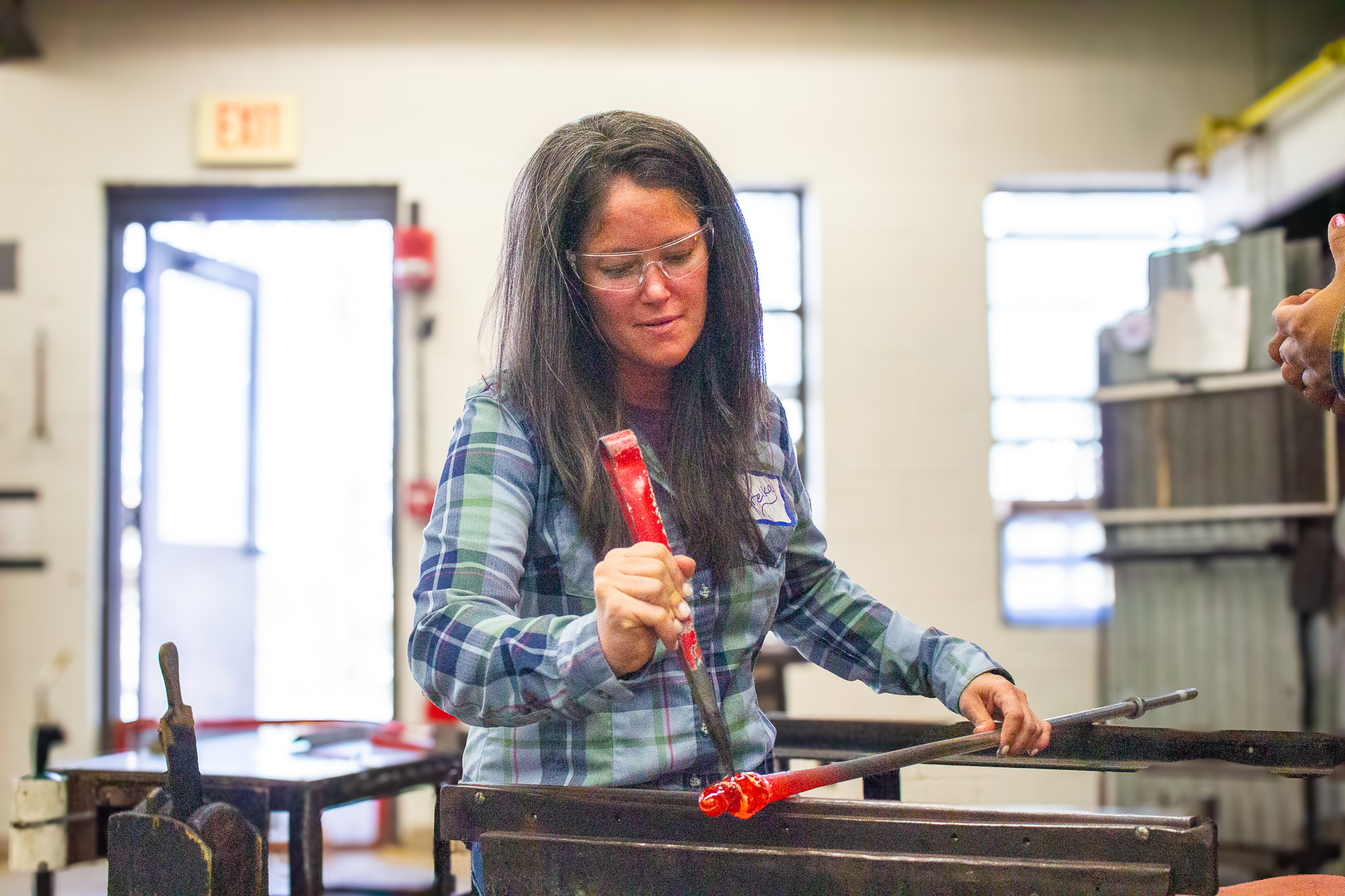 woman blowing glass