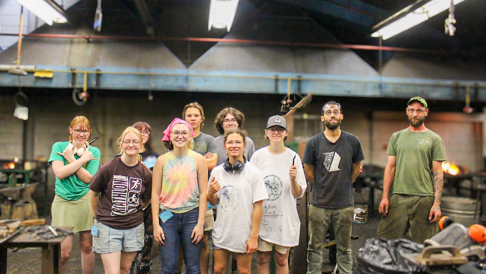 A group of students posing in the metal shop.