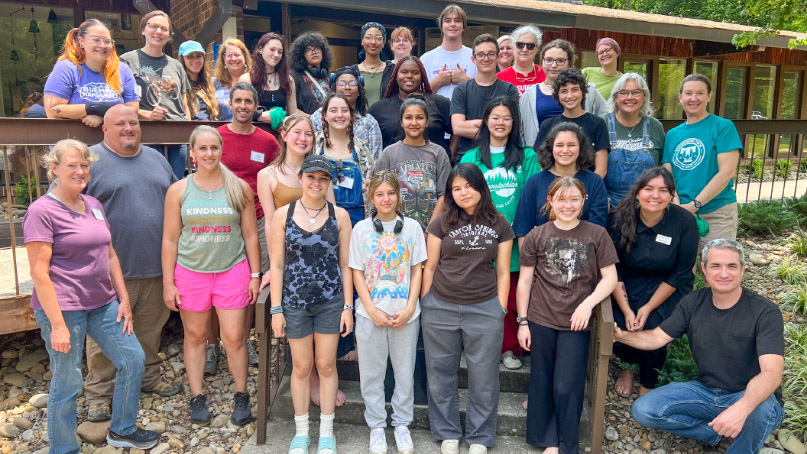 A large groupf of students posing in front of the Craft Center building.