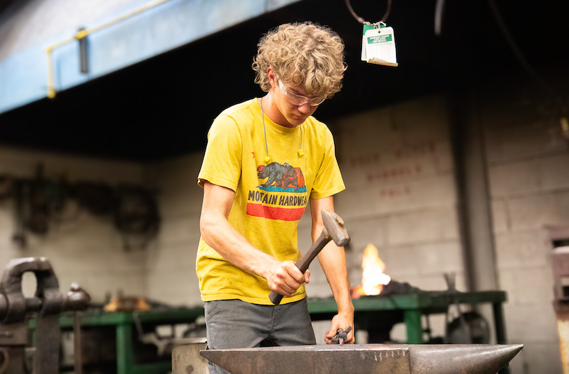 Student blacksmithing