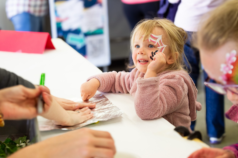 girl smiling and crafting