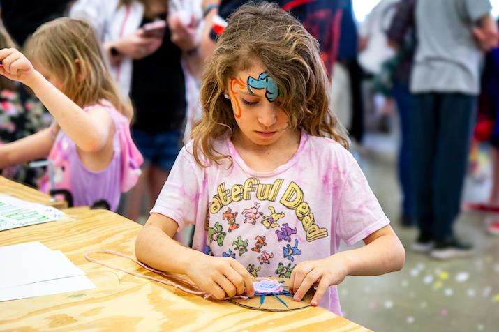 girl looking down crafting