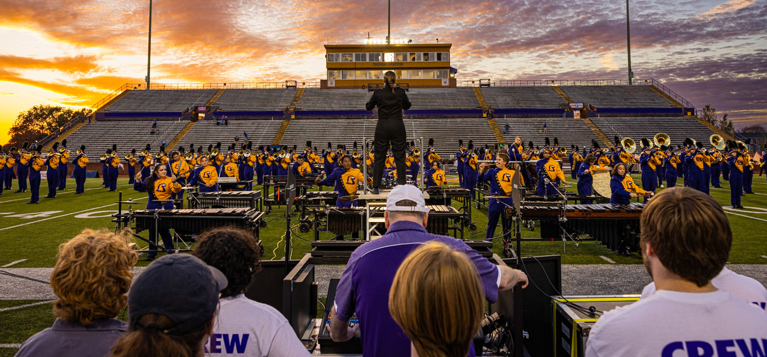 The live audio crew managing the audio for the TN Tech marching band at a football game.