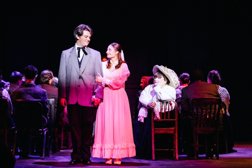 George Gibbs and Emily Webb at end of wedding with Mrs. Soames looking on, Our Town on stage at the Backdoor Playhouse 