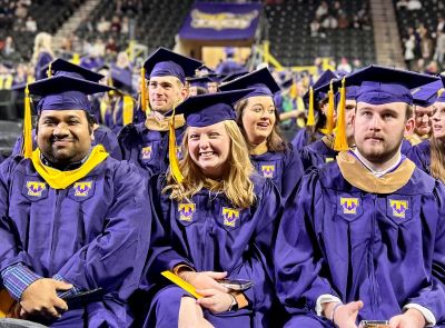 Fall 2024 graduates waiting for commencement to begin.