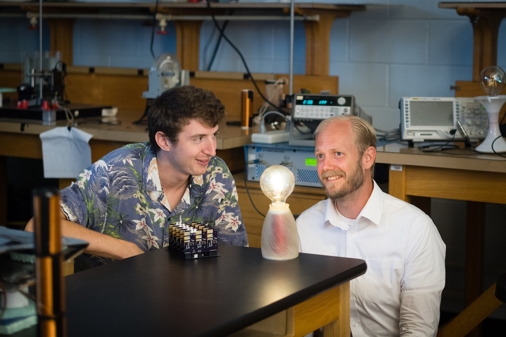 Electrical engineering master’s student Tanner Mingen, left, looks at the wireless charging module with Charles Van Neste, research assistant professor with CESR.
