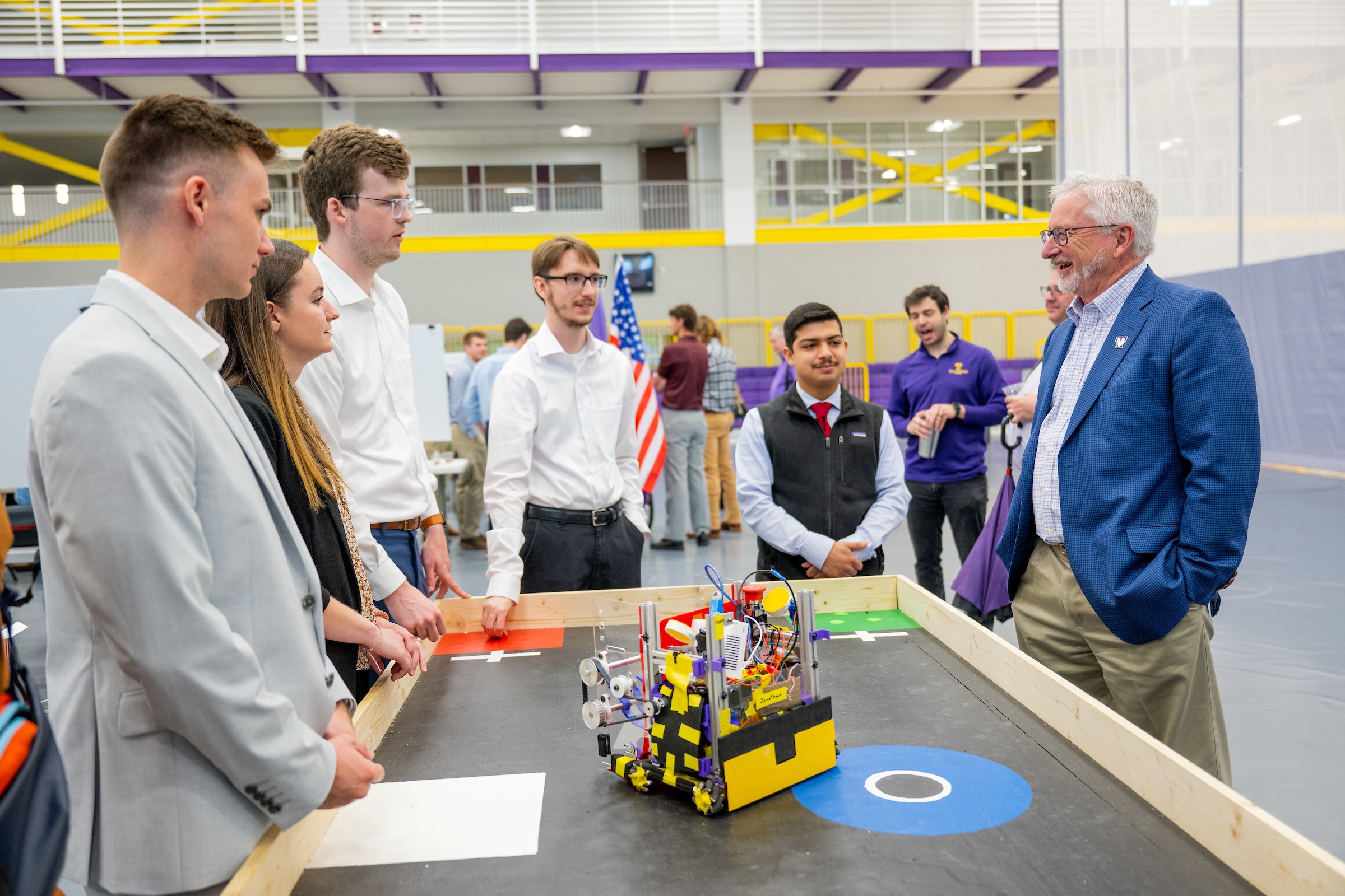 Tech President Phil Oldham (right) surveys a research project at Tech’s annual Research and Creative Inquiry Day. 