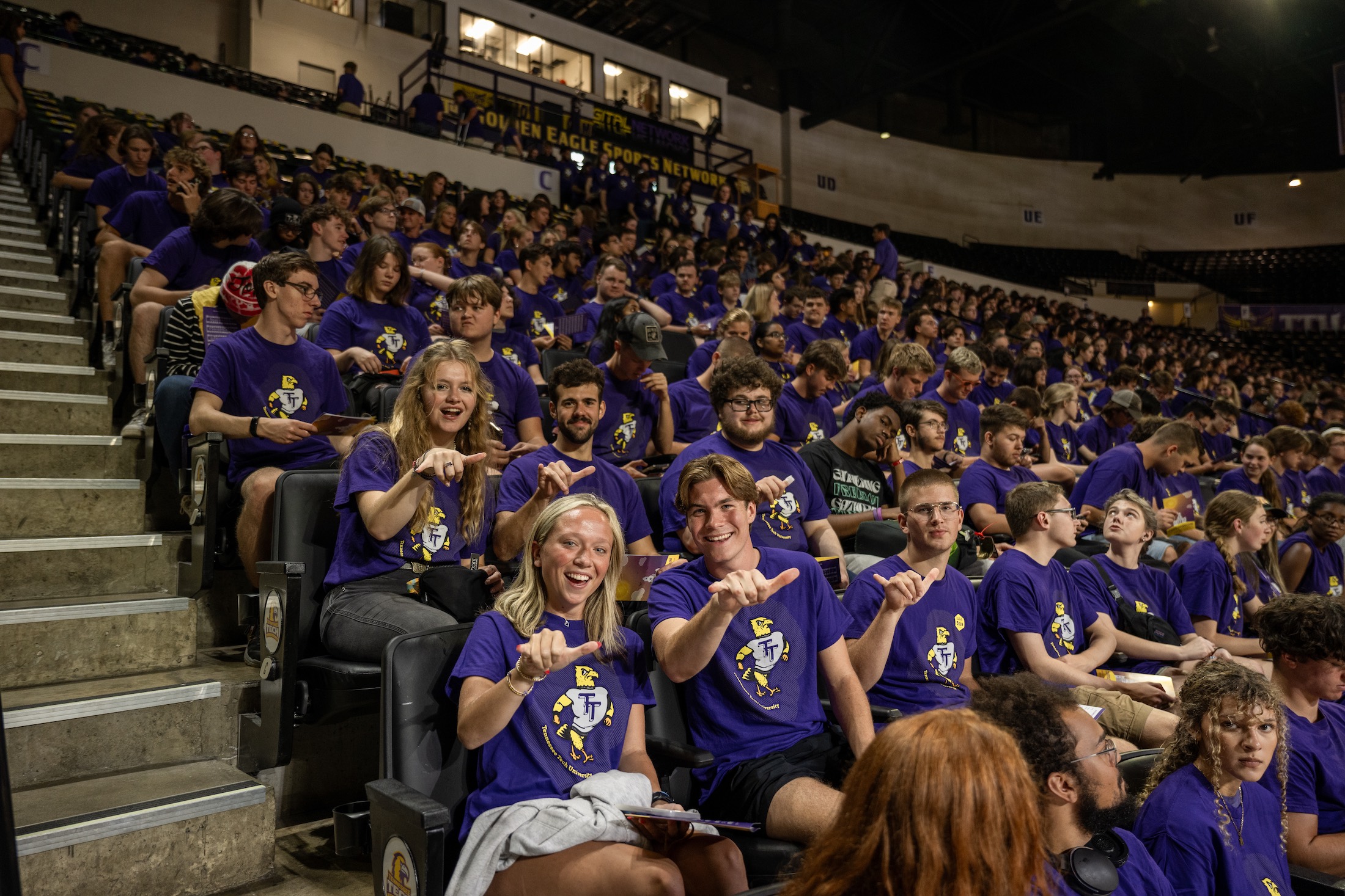 Freshman students give a "Wings Up" hand signal at Tech's fall convocation on Aug. 19, 2024.