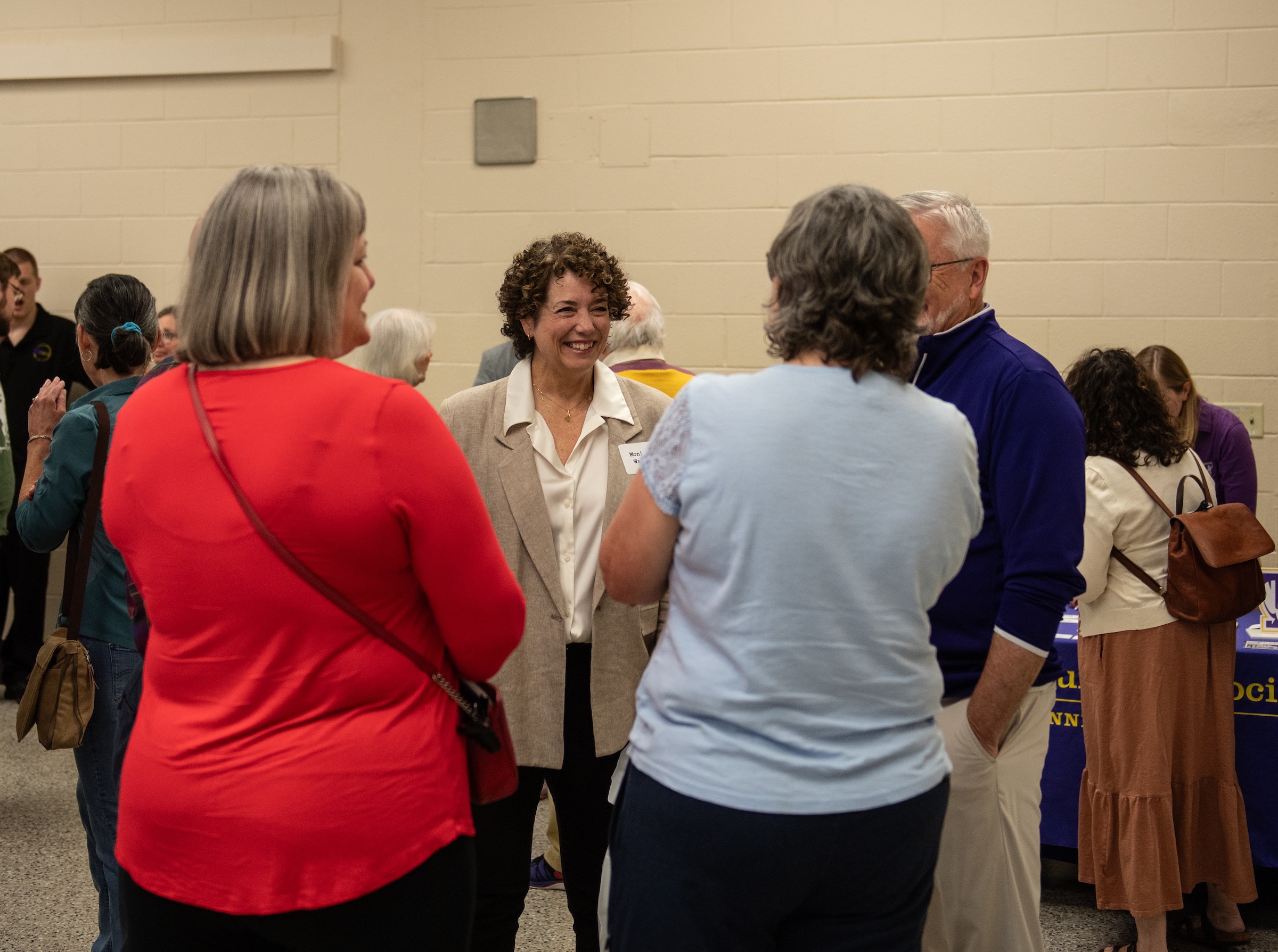 Monica Greppin Watts (center), a former Oracle staff member and the university's former associate vice president for communication and marketing, speaks with Tech President Phil Oldham (right) and other guests at the university's reunion event.