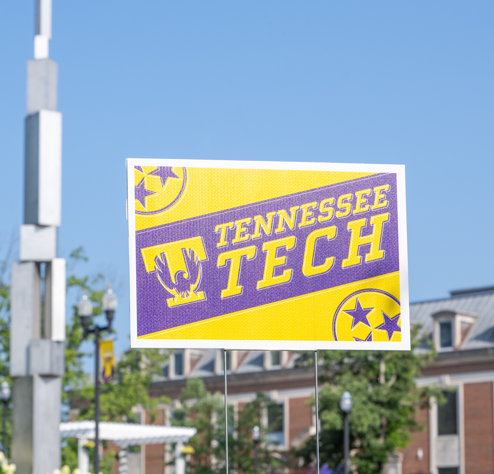 A Tennessee Tech yard sign is seen outside the Roaden University Center. The university's “Ascension” sculpture is shown at left. 