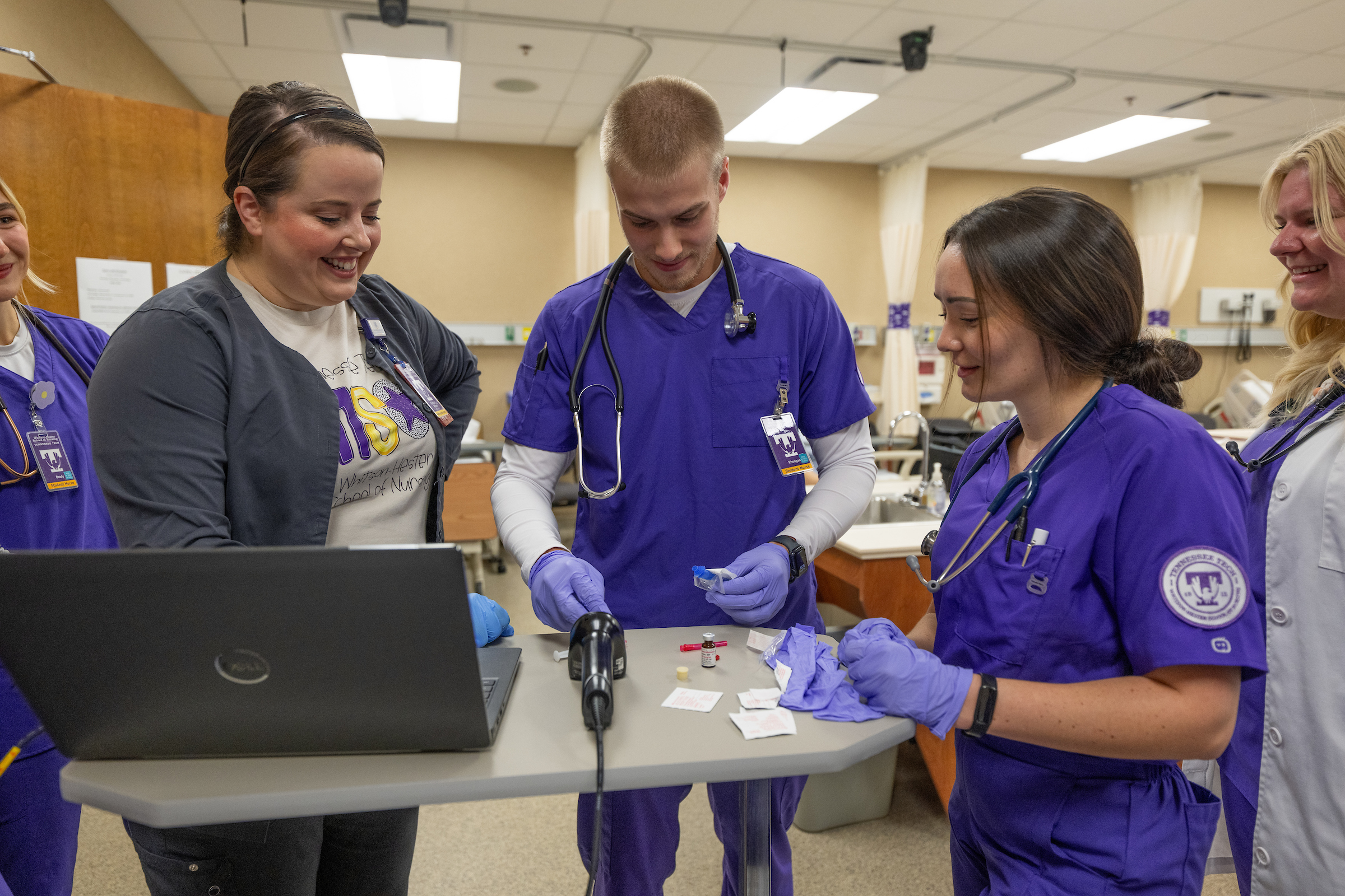 Nursing students participating in a demonstration on drawing medicine with Nursing professors