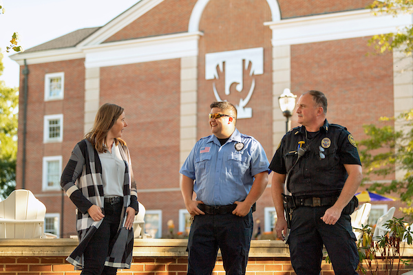 Police officers talking to a woman