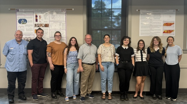 Group of College of Arts & Sciences students take photo with the dean and Provost Latour