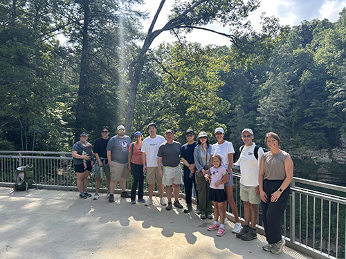 Provost Latour takes photo with faculty, staff, and their children at Cummins Falls